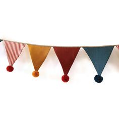 a colorful bunting banner with tassels hanging from it