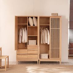 an open wooden cabinet with clothes hanging on it