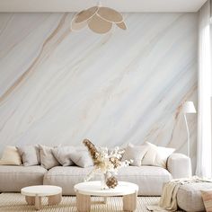 a living room filled with furniture and a large marble wall behind the couches is a white coffee table