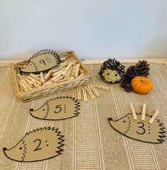 three hedges and two pine cones are on the table with clothes pins in front of them