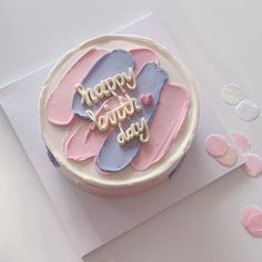 a birthday cake with pink and blue frosting that says happy birth day on it