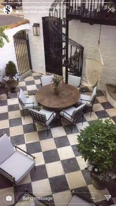 an outdoor dining area with chairs, table and hammock