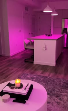 a living room filled with furniture and a lit candle on top of a coffee table