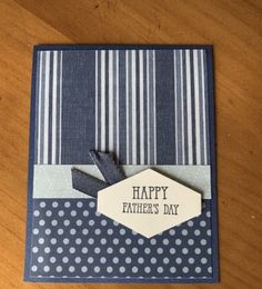 a father's day card on a table with blue and white striped paper, polka dots