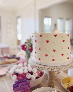 a table topped with lots of different types of cakes and cupcakes on top of it