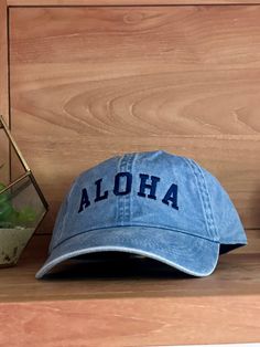 Add some tropical flair to your outfit with our Aloha baseball hat! Perfect for sunny days at the beach or just adding a pop of color to your look. Keep cool and stylish with this playful hat. (No one will be able to resist saying "aloha" to this hat!) Swimwear Store, Beach Beauty, Swim Shop, Keep Cool, One Piece Swim, Hats For Sale, Baseball Hat, Accessories Branding, Scarf Hairstyles