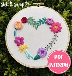 a heart shaped embroidery kit with flowers on it