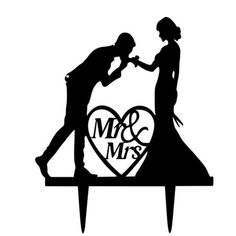 a cake topper with the silhouette of a man and woman holding hands in front of a heart