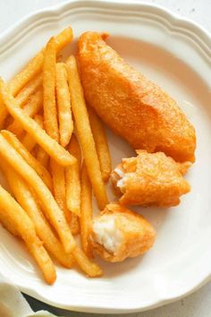 fried fish and french fries on a white plate