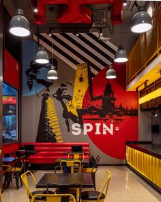 the inside of a restaurant with tables and chairs in front of a large mural on the wall