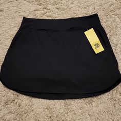 New Athletic Skort Has Pockets On Both Sides Solid Black Black Sports Skort With Pockets, Sporty Black Skort With Pockets, Moisture-wicking Black Skort For Sports, Black Moisture-wicking Skort For Sports, Sporty Black Moisture-wicking Skort, Black Tennis Skirt With Pockets For Sports, Moisture-wicking Black Skort For Gym, Casual Black Moisture-wicking Skort, Black Moisture-wicking Skort For Gym