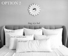 the bed has white pillows on it and is next to a clock that says option 2