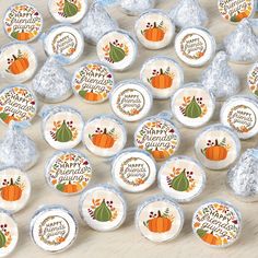 some candy wrapped in foil and decorated with pumpkins, leaves and words on them