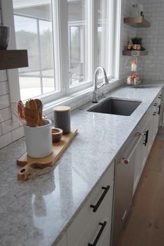 the kitchen counter is clean and ready to be used for cooking or baking, as well as cutting board with utensils on it