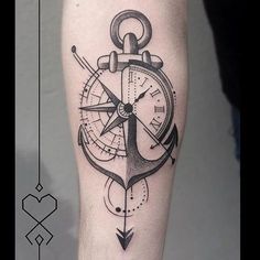 an anchor and compass tattoo on the left leg, which is also in black ink