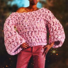 a woman wearing pink pants and a crocheted sweater with sequins on it