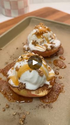 two small pastries with toppings on top of them are sitting on a tray