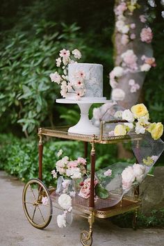 a three tiered cake sitting on top of a cart