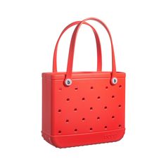 an orange tote bag with holes on the front and side, sitting against a white background