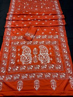 Gorgeous Orange Color saree with handwoven Kantha stitch work in white color. Item: SareeColor : Orange with White Color Kantha Base Fabric: Bangalori Silk Blouse piece : YesBlouse material: Bangalori Silk Work: Handloom, Kantha Work Fall & Edging (Yes/No) : Yes Occasion: Party, Festival, Traditional, Religious, House-warming. Disclaimer -:- Color variation is possible due to various reasons like phone or desktop setting, resolution etc. Please don't hold us responsible. Our aim is to put the ex Traditional Orange Cotton Saree, Orange Blouse With Traditional Patterns For Puja, Unstitched White Blouse Piece With Traditional Patterns, Orange Blouse Piece With Traditional Patterns And Drape, Traditional Orange Blouse Piece With Motifs, Traditional Orange Blouse With Motifs, Orange Chikankari Embroidery Saree For Diwali, Orange Blouse Piece With Traditional Patterns For Festivals, Orange Blouse Piece With Traditional Patterns