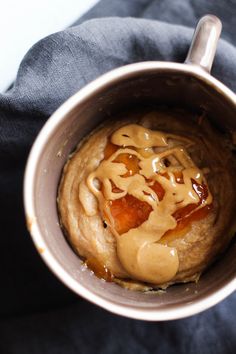 a cup filled with food sitting on top of a blue blanket