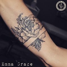 a woman's arm with a flower on it and the words ema grace written in