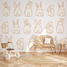 a child's room decorated in white and gold with bunny ears on the wall