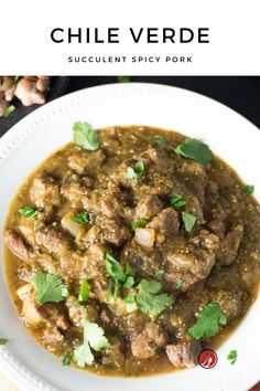 a white plate topped with meat and cilantro sauce