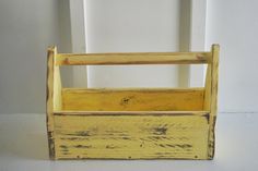 an old yellow wooden crate sitting on the floor