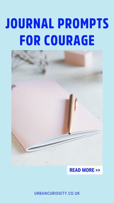 a pink notebook sitting on top of a table