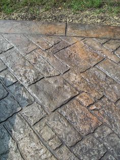 an image of a brick sidewalk with grass in the background