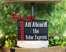 a black and red sign that says, all aboard the polar express on it's side