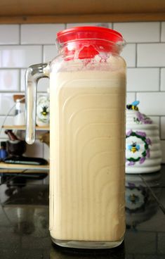 a glass jar filled with liquid sitting on top of a counter