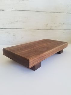 a wooden shelf sitting on top of a white table