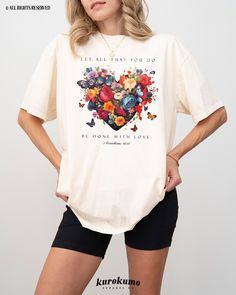 This Unisex garment-dyed t-shirt features "Let all that you do be done with love. | 1 Corinthians 16:14" with a gorgeous heart shape filled with vintage flowers and butterflies. Spread God's word with this floral Christian tee <3 » A B O U T « ‣ This item is made to order using direct-to-garment (DTG) printing technology. This digital process involves the printer inks being jetted or sprayed onto the textile by a print head after the garment goes through a pre-treatment machine to create a stron Indie Graphic Tees, Scripture Shirts, Bible Verse T Shirt, Done With Love, Love Bible, Scripture Shirt, Faith Based Clothing, Bible Verses About Love, Flowers And Butterflies