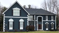 a blue house with white trim and black shutters