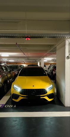 a yellow car parked in a parking garage