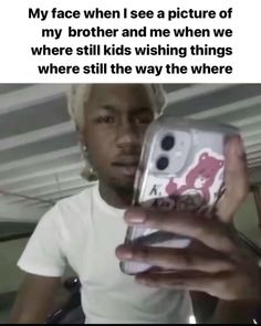 a person holding up a cell phone in front of their face and the caption reads, my face when i see a picture of my brother and me when we were still kids wishing things where