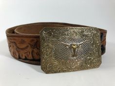 Tooled Leather Belt Size is not marked, but the leather measures 29" from end to end.  I think it's probably about a size 24, but please check measurements. 1 1/2" wide Brown and black leather with a western floral design Minor wear.  There are no holes or clasp for the buckle to attach to, but holes could easily be added with a leather punch.  Please be sure to look closely at all photos for details.Please let me know if you have any questions.  Thanks for looking. Check out my other items for Tooled Leather Belts, Tooled Leather, Leather Tooling, Belt Size, Leather Belt, Things To Think About, Floral Design, Black Leather, Let Me