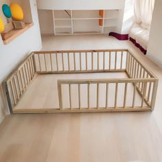 a wooden baby crib sitting in the middle of a room