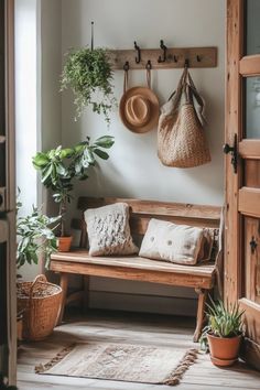 a wooden bench sitting in the middle of a room next to potted plants and hanging baskets