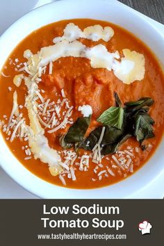 a bowl of tomato soup with cheese and spinach