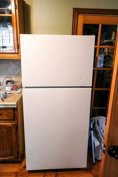 a white refrigerator freezer sitting inside of a kitchen