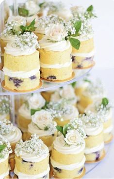 several tiered cakes with flowers on them