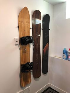 three snowboards mounted to the wall next to each other