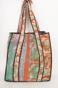 This bag is made from a vintage hand-stitched Kantha quilt. We make only 1-2 bags from each quilt and every one of them is one of a kind! Details: Shell fabric- Vintage quilted cotton Kantha 1. width (cm) - 35 2. height (cm)- 45 3. depth (cm) - 35 4. weight (g)- 0.400 kg 5. length of shoulder (cm) -25 cm Care instructions: Dry clean or Hand-wash in warm water. Drip dry. How it's made: Kantha quilts are made using numerous layers of recycled silk or cotton saris which are hand-stitched in the tra Green Quilted Square Bag, Square Green Quilted Bag, Green Quilted Shopping Bag, Green Quilted Rectangular Bag, Green Quilted Bag For Daily Use, Upcycled Multicolor Tote Bag, Rectangular Upcycled Bag For Daily Use, Rectangular Upcycled Bags For Daily Use, Multicolor Upcycled Tote Bag