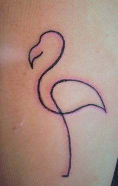 a flamingo tattoo on the back of a woman's stomach