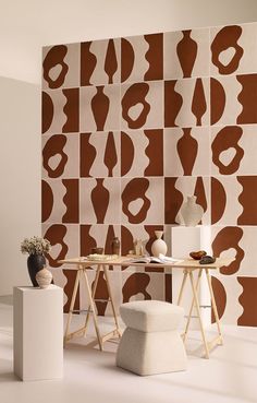 a room with an abstract wallpaper design and two stools in the foreground