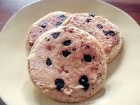 three chocolate chip cookies on a white plate