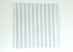 a white and blue striped napkin sitting on top of a table